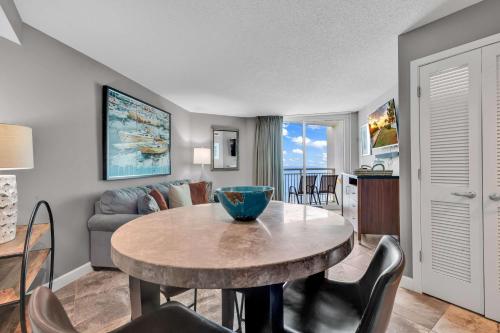 a living room with a table and a couch at Oceanfront Perfect Couples Getaway in Myrtle Beach