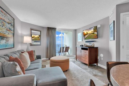 a living room with a couch and a table at Oceanfront Perfect Couples Getaway in Myrtle Beach