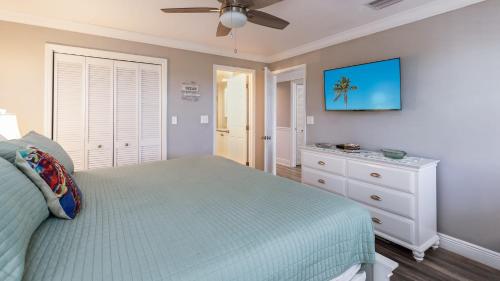 a bedroom with a bed and a ceiling fan at Sea View and Sunrise Top Floor Ocean Pointe 2412 in Key Largo