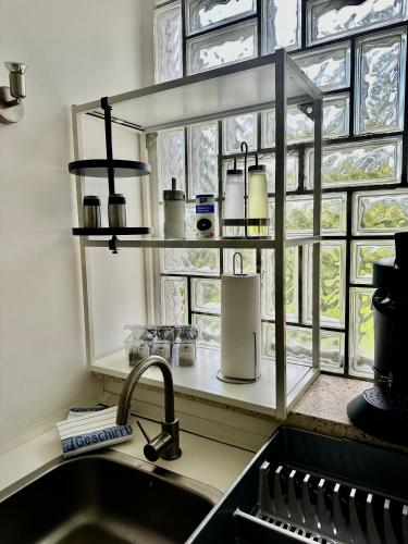 a kitchen counter with a sink and a window at Apartment in ruhiger Lage-Waschmaschine-Balkon in Wolfsburg