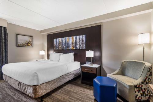 a hotel room with a bed and a chair at Best Western Atlanta-Marietta Ballpark Hotel in Atlanta