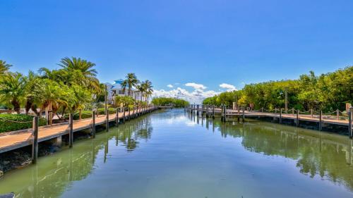 a river with palm trees and a bridge at Key Largo Sunrise Resort Style Ocean Pointe 5315 in Key Largo