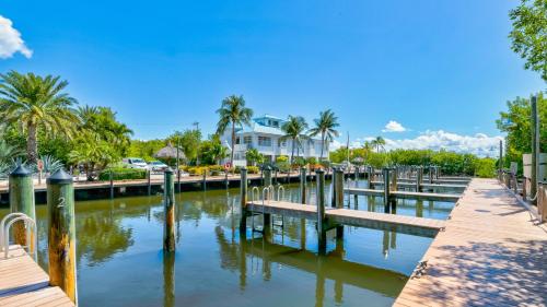 a marina with palm trees and a house at Key Largo Sunrise Resort Style Ocean Pointe 5315 in Key Largo