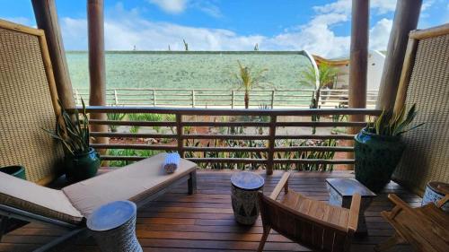 a balcony with chairs and a view of the ocean at Filho do Vento Kite & Lodge in Canguaretama
