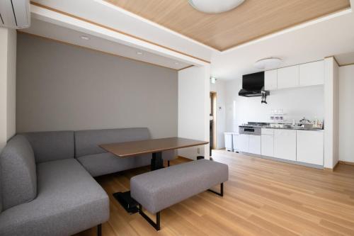 a living room with a couch and a table at Casa Stay Kokura 2 - Vacation STAY 27406v in Itabitsu