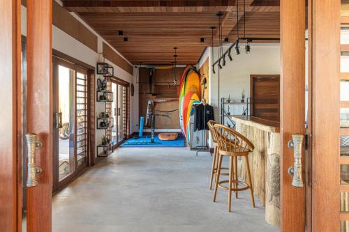 a room with a bar with a chair in it at Filho do Vento Kite & Lodge in Canguaretama