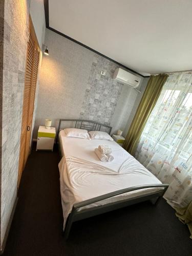 a bedroom with a bed with a teddy bear on it at Zlata Ultracentral Apartment MV16 in Suceava