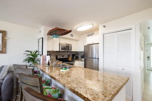 a kitchen with a counter top and a refrigerator at Flamingo Flats Ocean Pointe 5306 in Key Largo