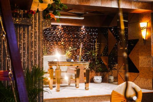 a room with a table and some plants at Coral Reef Hotel & Spa, Port Blair in Port Blair
