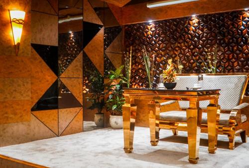 a dining room with a wooden table and chairs at Coral Reef Hotel & Spa, Port Blair in Port Blair