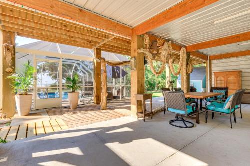 a wooden porch with a wooden table and chairs at Waterfront Gulf Coast Home with Outdoor Oasis! in Gautier