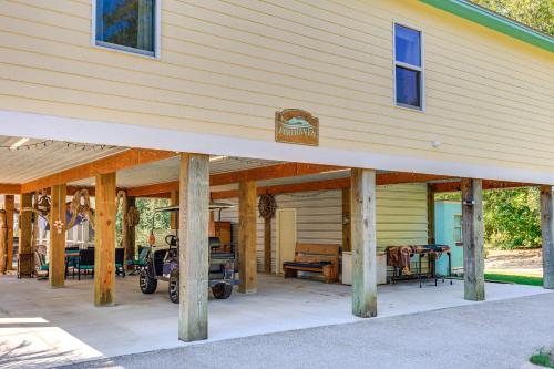 a covered porch of a house with wooden beams at Waterfront Gulf Coast Home with Outdoor Oasis! in Gautier