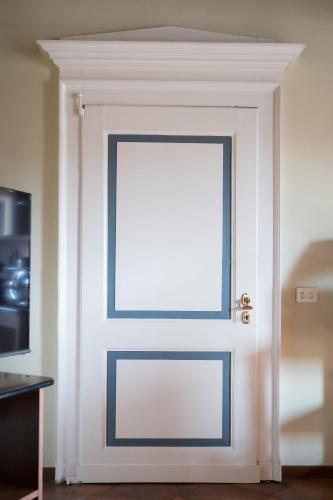 a white door with a window in a room at Antica Casa Balsari in Borgo Ticino