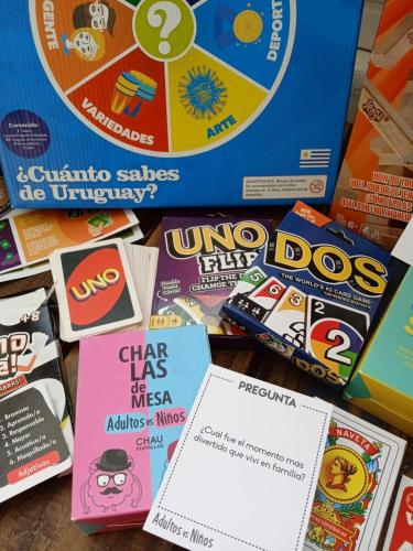 a pile of childrens board games on a table at Carmela Suites Cabo Polonio in Cabo Polonio