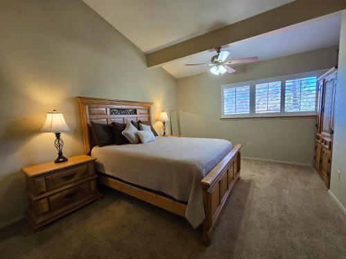 a bedroom with a bed and a ceiling fan at Grisham's View Condo: Central Condo with a Golf Course View! in Ruidoso
