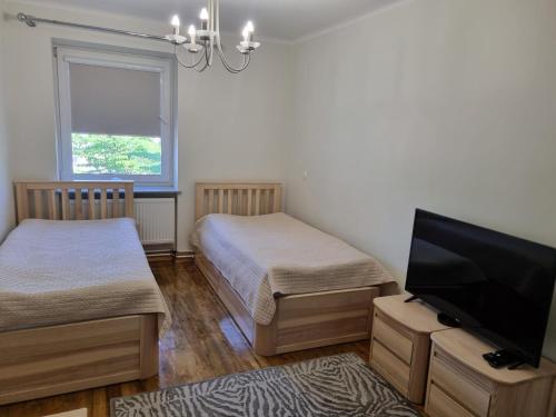 Postel nebo postele na pokoji v ubytování Neris apartments