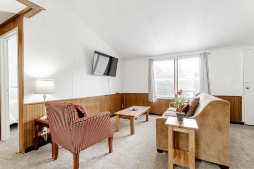 a living room with a couch and a table at Gamecock Roost- 15mins to Downtown- Back unit in Columbia