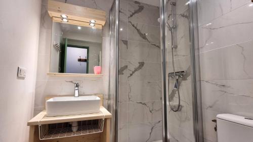 une salle de bain avec un lavabo et une douche dans l'établissement Résidence Le France - Résidence LE FRANCE N°939 MAE-5421, à La Plagne Tarentaise
