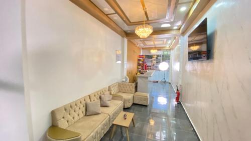 a living room with a couch and a table at Hotel Mall plaza in Santa Marta