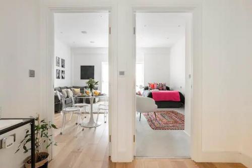 a white room with a living room with a table at Superb 1-Bed Apartment in Hertfordshire in Welwyn Garden City