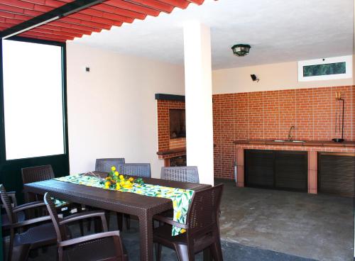 a dining room with a table and chairs and a fireplace at Madeira Home Spacious Accommodation in Funchal