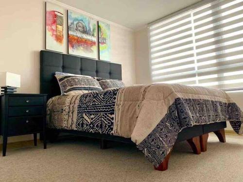 Un dormitorio con una cama grande y una ventana. en Almanova Sunset, en Antofagasta