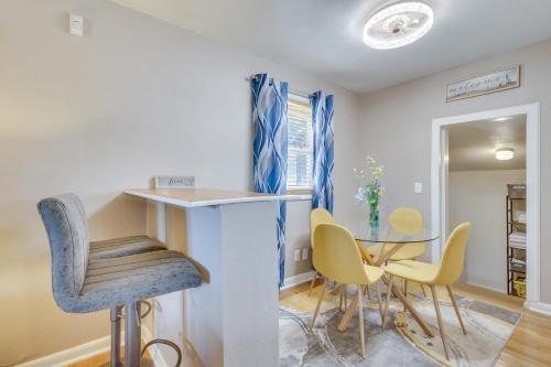 a dining room with a table and chairs at 4 Mi to Dtwn Home with Fenced Yard in Portsmouth! in Portsmouth