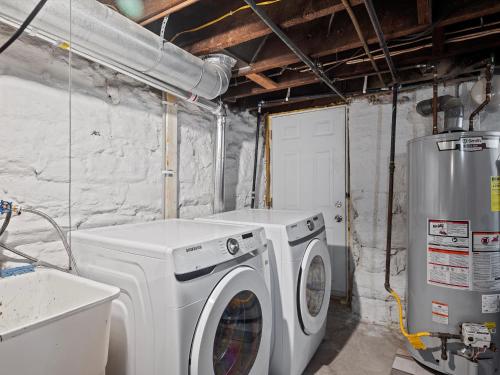 a laundry room with a washing machine and a washer at Oakland, Pittsburgh !A Modern and Stylish Private Bedroom with Shared Bathroom in Pittsburgh