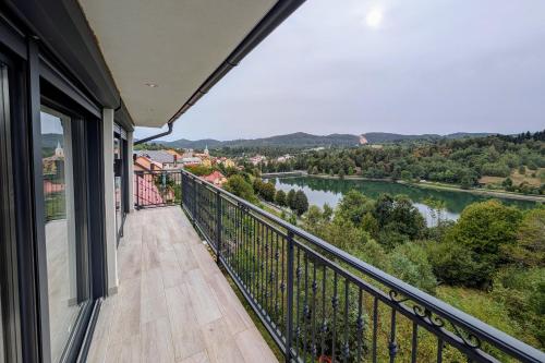a balcony with a view of a river at Fuzine Lake Apartments in Fužine