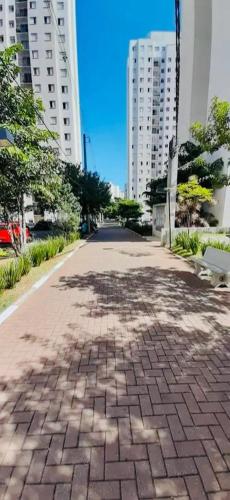 a brick walkway in a city with tall buildings at Aeroporto de Guarulhos 2 in Guarulhos