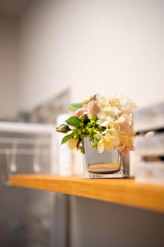 a vase filled with flowers sitting on a table at LHE Maison Almerici in Cesena
