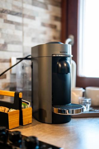 a coffee maker sitting on top of a table at LHE Maison Almerici in Cesena