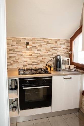 a kitchen with a stove and a counter top at LHE Maison Almerici in Cesena