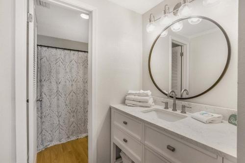 a bathroom with a sink and a mirror at Phoenix VIII 8904: Sand Shells and Sun in Orange Beach