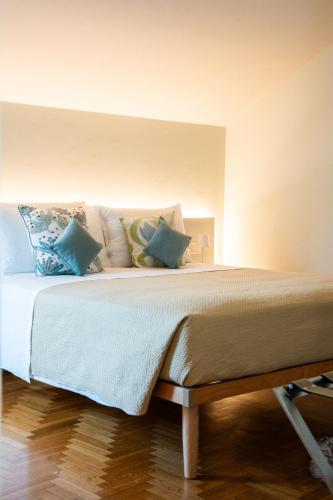 a bed with pillows on it in a room at LHE Maison Almerici in Cesena
