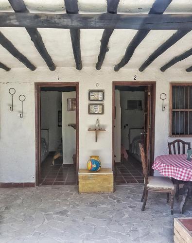 a patio with a table and chairs and a ceiling at Posada la Arcadia in Pedro Gonzalez