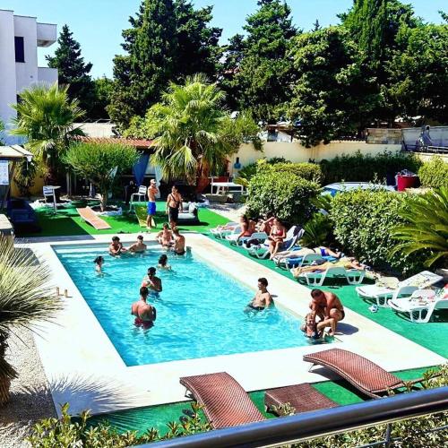 a group of people in a swimming pool at Kristal Paris Resort in Novalja