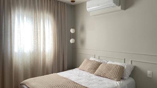 Ένα ή περισσότερα κρεβάτια σε δωμάτιο στο Apartamento em Dourados, Sunset