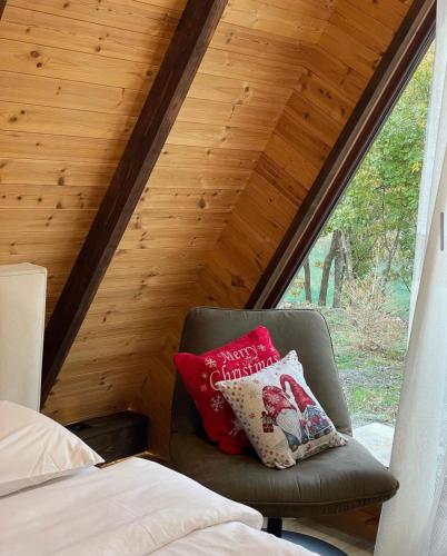 a chair with two pillows sitting in a bedroom at Agora Farmhouse in Koman