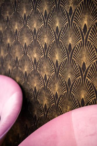 a wall with a brown and gold wallpaper at LHE Les Trois Merveilles in Cesena