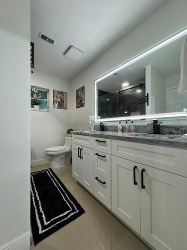 a white bathroom with a sink and a toilet at Beautiful and comfy home! in Seffner