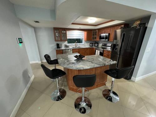 a kitchen with a island with a granite counter top at Beautiful and comfy home! in Seffner
