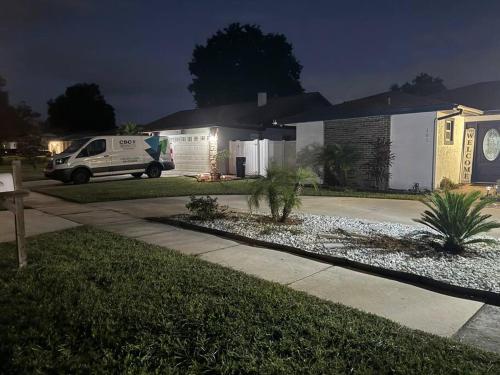 a house with a van parked in a driveway at Beautiful and comfy home! in Seffner