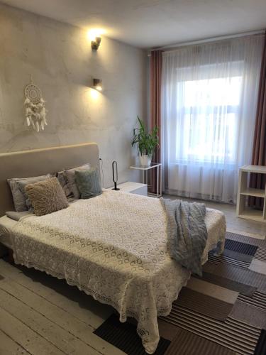 a bedroom with a large bed and a window at Old Town Apartment nr 9 in Valga