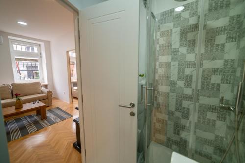 a bathroom with a shower with a glass door at Four Seasons Apartments in Sarajevo