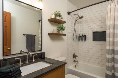 a bathroom with a sink and a tub and a mirror at Gorgeous Cabin 3 Rooms & 2 Baths in Bailey
