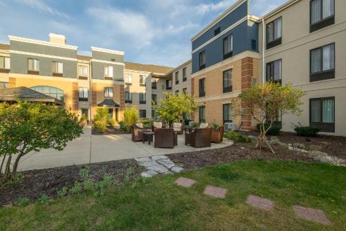 an apartment courtyard with furniture and buildings at Staybridge Suites Middleton/Madison-West by IHG in Middleton