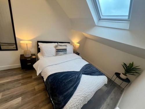 a small bedroom with a bed with a window at 2 Bed Preston City Centre Flat - Sleeps 4 with parking in Preston