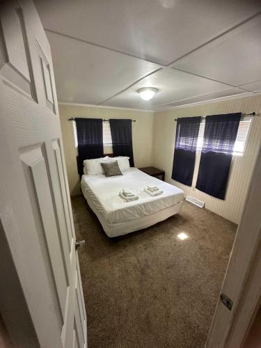 a bedroom with a white bed in a room at 15mins to Downtown- Adorable on Taylor Both Units in West Columbia