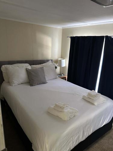 a bedroom with a bed with towels on it at 15mins to Downtown- Adorable on Taylor Both Units in West Columbia